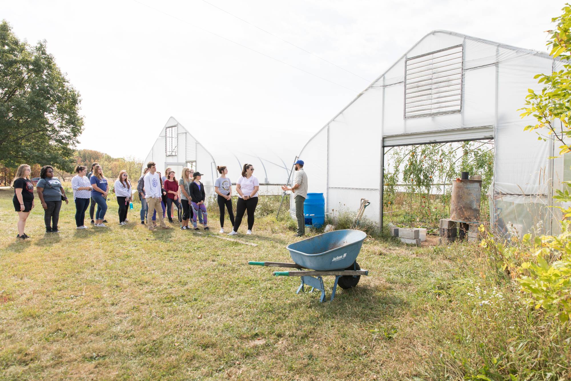 Youseff, the Farm Manager, teaches a group of volunteers about composting